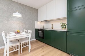 Kitchenette with an oven and dining space ideal for family meals.