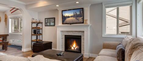 Living Room with large sectional sofa/sleeper sofa, gas fireplace, and 48" Samsung smart tv
