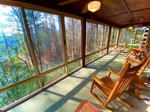 This expansive sunroom is accessible from the side deck and from the living room. Take in the sunrise while sipping
coffee on the rockers or swing. Slide open the windows and/or the screens to breathe in the fresh air and unite with
nature!