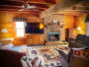 The living room and its heating fireplace compete with the great outdoors for your attention. Who can resist curling up
by the fire? A cabinet full of games and DVDs can entertain the whole group. Or watch a movie on your 70" ROKU
television.