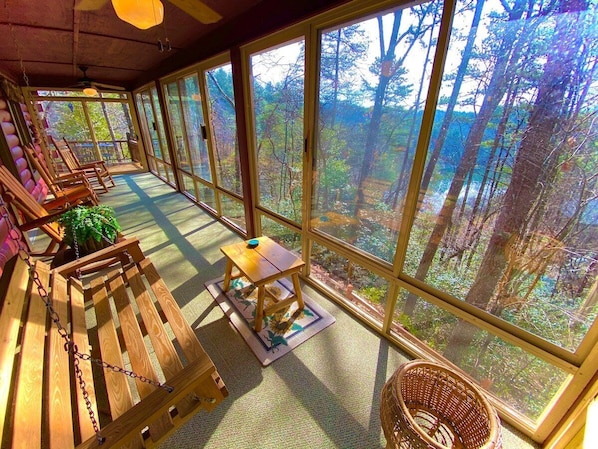 A view from the opposite end of the massive sunroom. Can't you just see yourself rocking away the evening, gazing
at the private lake that peeks through the trees and listening to the many birds happily chirping their morning songs?