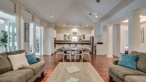 Enjoy sunroom & pool views under vaulted ceilings.