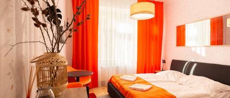 Orange room with kingsize bed and ensuite bathroom