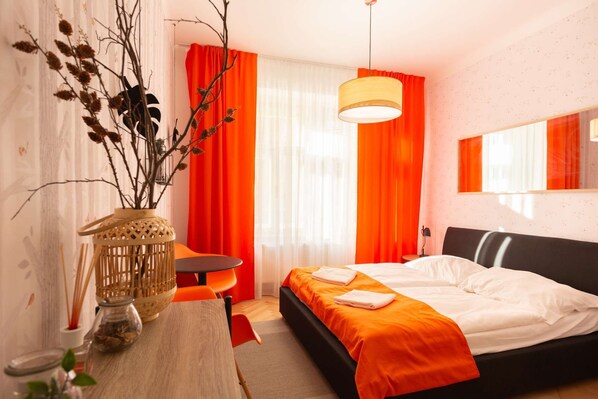 Orange room with kingsize bed and ensuite bathroom