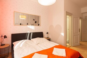 Orange room with kingsize bed and ensuite bathroom