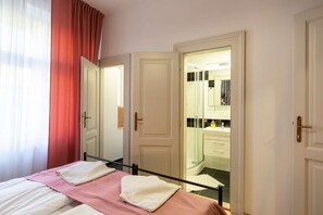 Pink room with kingsize bed and ensuite bathroom