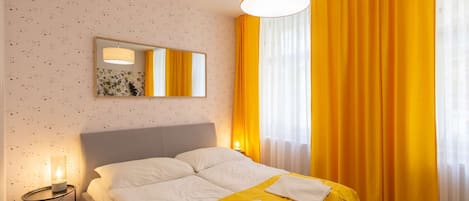 Yellow room with kingsize bed and ensuite bathroom