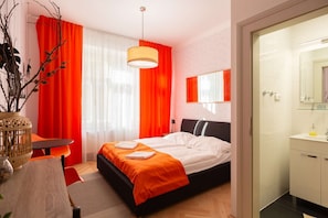Orange room with kingsize bed and ensuite bathroom
