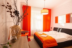 Orange room with kingsize bed and ensuite bathroom