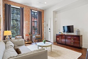 Living room space equipped with large TV perfect for Netflix! 