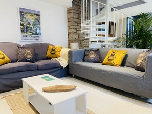 The open plan living room, dining room and kitchen.