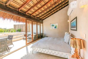 Palapa roof in the master bedroom w/ open doors to the pool & terrace