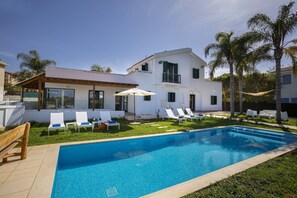 Front garden with private pool and outdoor furniture including sunloungers