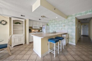The spacious kitchen is updated & well stocked for preparing family meals.
