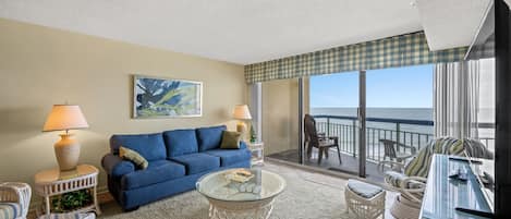 Relax in the comfort of a large well-appointed living room with an ocean view.