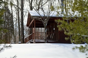 Snowy view of side of Cabin 14