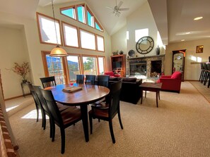 Gather around the elegant dining table, which seats eight, and enjoy meals with a backdrop of stunning ski slope views.
