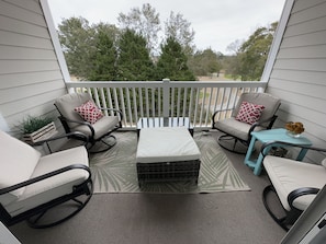 Balcony overlooking the golf course, with 4 swivel rockers and an ottoman