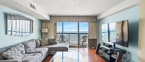 Relax in the comfort of a large well-appointed living room with an ocean view.