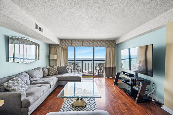 Relax in the comfort of a large well-appointed living room with an ocean view.