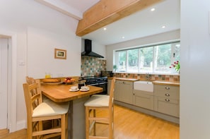 The comprehensively fitted kitchen with views of the forest.