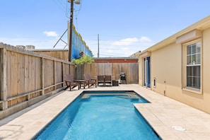 Back yard with comfortable sitting and a propane grill.