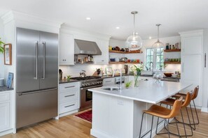 Open wood shelves and plenty of cabinets and drawers. 