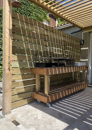 An electric plancha and charcoal grill on the terrace