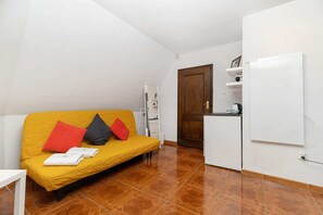 The living area's bold color palette creates a cheerful and inviting atmosphere.