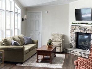 Cozy and Airy Living Room with Roku TV, Gas Fireplace, Picture Windows