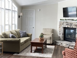 Cozy and Airy Living Room with Roku TV, Gas Fireplace, Picture Windows