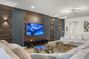 Living area with oversized sectional sofa and flat screen TV