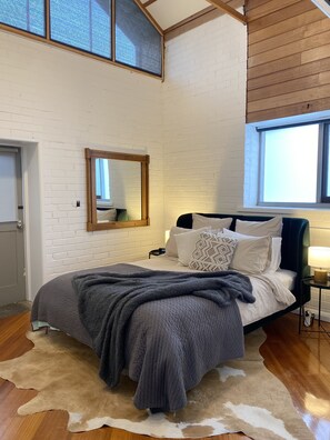 The second queen bedroom featuring cathedral ceilings and highlight windows