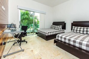 The master has two queen beds and access to private balcony