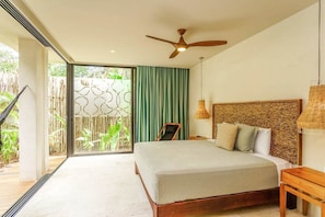 Master bedroom with king bed and beautiful natural decor
