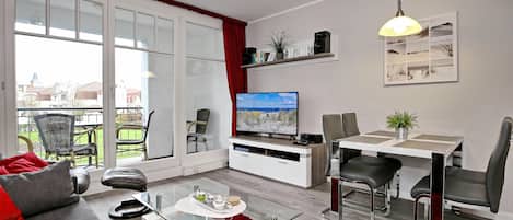Wohnzimmer mit Esstisch und TV