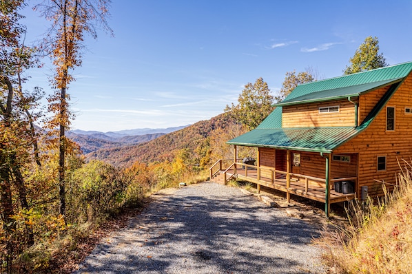 View of the cabin and mountains from the driveway