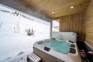 Ski-in to your home and hop in the private hot tub! This thoughtfully designed home is carved into the mountainside and offers unparalleled views, ame