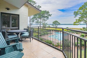 Step out onto the partially covered balcony to enjoy these views of the pool, marsh grasses and water.