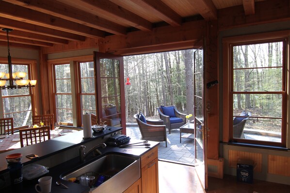 Kitchen flows on to outdoor patio, light filled, open views. 