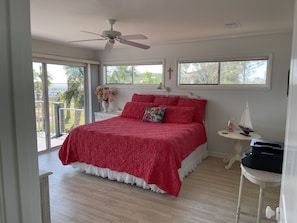 The master bedroom opens up to the bay deck for your morning coffee enjoyment
