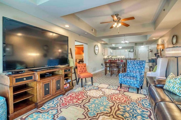 This cozy and serene space features an impressive 85" high-definition television, a comfortable leather recliner sofa, and ample seating options for the family. The TV offers access to popular streaming services such as Netflix, Disney, Hulu, etc.