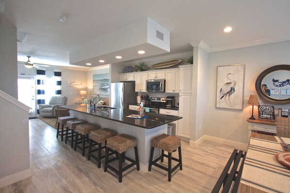 All can gather and enjoy the wide open living space. Kitchen island seats 6. 
