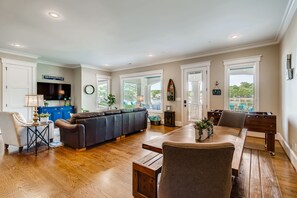 Family room with foosball table and deck access.
