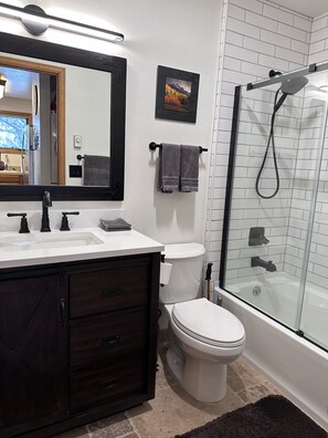 Main floor bathroom with bathtub. Across from the Kitchen.