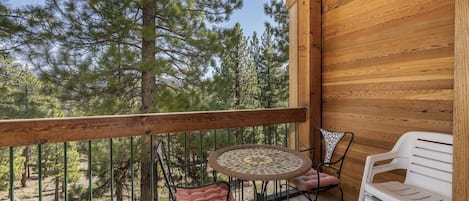 Main living space deck w/BBQ, chairs and a small table