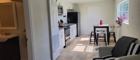 Kitchen area and bathroom. Full kitchen: oven, microwave, fridge, coffee maker. 