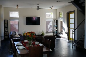 Open living and dining area with an smart tv.