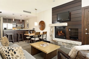 This beautifully appointed living area offers a fully stocked kitchen, gas fireplace, and a flat screen TV