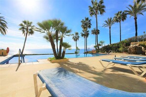 Communal sun loungers available on the swimming pool area